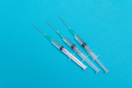 Several Syringe on Blue Table. Disposable Plastic Syringes are Prepared for Vaccination or...