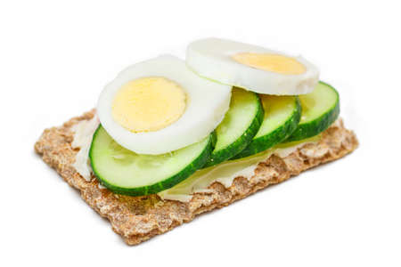 Whole Grain Crispbread with Fresh Cucumber, Egg, Cream Cheese and Radish - Isolated on White. Quick and Healthy Sandwiches. Crispbread with Tasty Filling. Healthy Dietary Snack - Isolationの写真素材