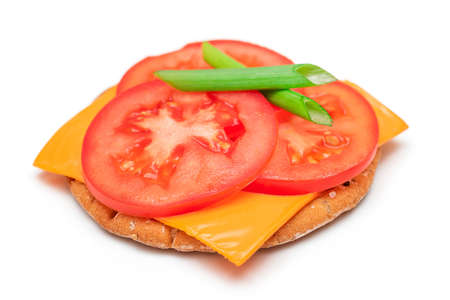 Crispy Cracker Sandwich with Tomato, Cheese and Green Onions - Isolated on White. Easy Breakfast. Quick and Healthy Sandwiches. Crispbread with Tasty Filling. Healthy Dietary Snack - Isolationの写真素材