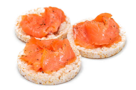 Tasty Rice Cake Sandwiches with Fresh Salmon Slices Isolated on White. Easy Breakfast and Diet Food. Crispbread with Red Fish. Healthy Dietary Snacks - Isolationの写真素材