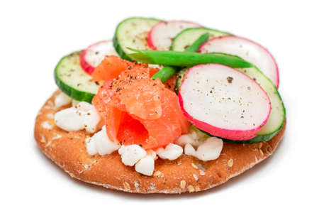 Crispy Cracker Sandwich with Salmon, Cucumber, Radish, Cottage Cheese and Green Onions - Isolated on White. Easy Breakfast. Quick and Healthy Sandwiches. Crispbread with Tasty Filling - Isolationの写真素材