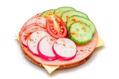 Crispy Cracker Sandwich with Fresh Cucumber, Cheese, Sausage, Radish and Tomato - Isolated on White. Quick and Healthy Sandwiches. Crispbread with Tasty Filling. Healthy Dietary Snack - Isolationの写真素材