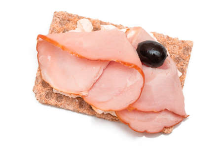 Whole Grain Crispbread with Ham, Cream Cheese and Olives - Isolated on White. Easy Breakfast. Diet Food. Quick and Healthy Sandwiches. Crispbread with Tasty Filling. Healthy Dietary Snack - Isolationの写真素材