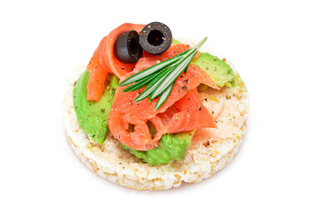 Rice Cake Sandwich with Fresh Salmon, Avocado and Olives - Isolated on White. Easy Breakfast. Diet Food. Quick and Healthy Sandwiches. Crispbread with Tasty Filling. Healthy Dietary Snack - Isolationの写真素材