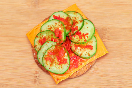 Crispy Cracker Sandwich with Fresh Cucumber, Cheese and Paprika on Cutting Board. Diet Food. Easy Breakfast. Quick and Healthy Sandwiches. Crispbread with Tasty Filling. Healthy Dietary Snackの写真素材