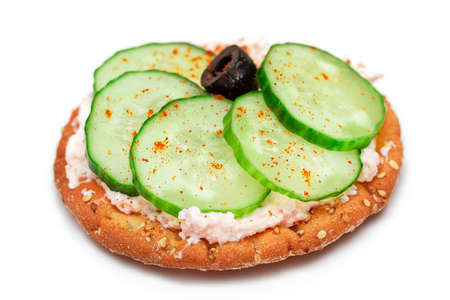 Crispy Cracker Sandwich with Fresh Cucumber, Fish Cream and Olives - Isolated on White. Easy Breakfast. Quick and Healthy Sandwiches. Crispbread with Tasty Filling. Healthy Dietary Snack - Isolationの写真素材
