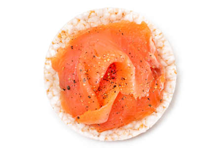 Tasty Rice Cake Sandwich with Fresh Salmon Slices Isolated on White - Top View. Easy Breakfast and Diet Food. Crispbread with Red Fish. Healthy Dietary Snack - Isolationの写真素材