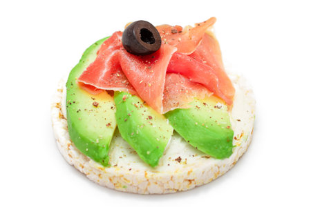 Rice Cake Sandwich with Fresh Avocado, Jamon and Olives - Isolated on White. Easy Breakfast. Diet Food. Quick and Healthy Sandwiches. Crispbread with Tasty Filling. Healthy Dietary Snack - Isolationの写真素材