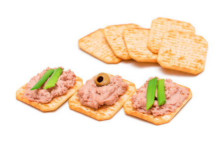 Crispy Salted Crackers with Liver Pate, Green Onions and Olives - Isolated on White. Easy Snack - Isolationの写真素材