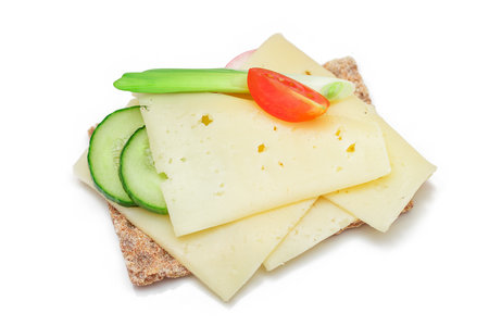 Whole Grain Crispbread with Cheese, Fresh Cucumber, Radish, Tomato and Green Onions - Isolated on White. Quick and Healthy Sandwiches. Crispbread with Tasty Filling. Healthy Dietary Snack - Isolationの写真素材