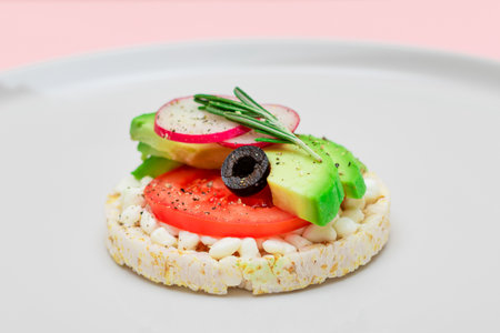 Rice Cake Sandwich with Avocado, Tomato, Cottage Cheese, Olives and Radish on White Plate. Easy Breakfast. Diet Food. Quick and Healthy Sandwiches. Crispbread with Tasty Filling. Healthy Dietary Snackの写真素材