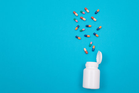Global Pharmaceutical Industry and Medicinal Products - Colored Pills or Capsules Scattered from the...