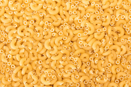 Uncooked Chifferi Rigati Pasta Background. Fat and Unhealthy Food. Classic Dry Macaroni Texture. Italian Culture and Cuisine. Raw Pastaの写真素材