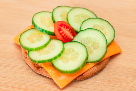 Crispy Cracker Sandwich with Fresh Cucumber, Tomato Cherry and Cheese on Cutting Board. Easy Breakfast. Diet Food. Quick and Healthy Sandwiches. Crispbread with Tasty Filling. Healthy Dietary Snackの写真素材