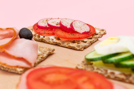 Different Whole Grain Crispbread with Ham, Tomato, Radish, Cucumber and Cheese. Easy Breakfast. Diet...