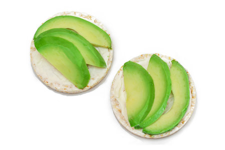 Rice Cake Sandwiches with Fresh Avocado and Cream Cheese - Isolated on White. Easy Breakfast. Diet Food. Quick and Healthy Sandwiches. Crispbread with Tasty Filling. Healthy Dietary Snack - Isolationの写真素材