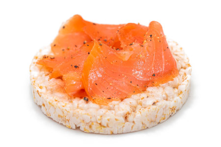 Tasty Rice Cake Sandwich with Fresh Salmon Slices Isolated on White. Easy Breakfast and Diet Food. Crispbread with Red Fish. Healthy Dietary Snack - Isolationの写真素材
