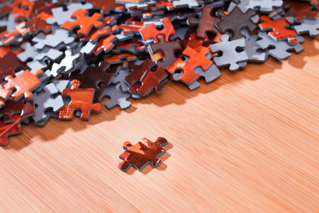 Colorful Peaces of a Mixed Jigsaw Puzzle Lie on the Wooden Table - Strategy and Solving Problem Conceptの写真素材