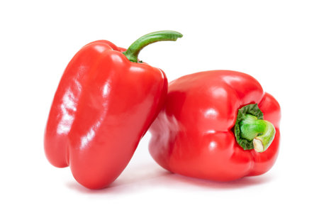 Two Fresh Red Sweet Bell Peppers Isolated on White Backgroundの写真素材