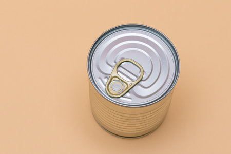 Unopened Tin Can with Blank Edge on Beige Background. Canned Food. Aluminum Can for Safe and Long...