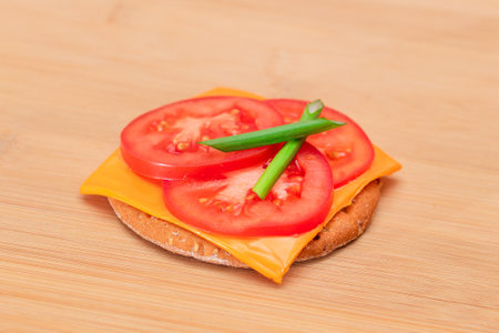Crispy Cracker Sandwich with Tomato, Cheese and Green Onions on Cutting Board. Easy Breakfast. Diet Food. Quick and Healthy Sandwiches. Crispbread with Tasty Filling. Healthy Dietary Snackの写真素材
