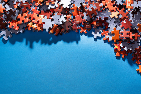 Mixed Peaces of a Colorful Jigsaw Puzzle Lie on the Blue Background With Copy Space - Strategy and Solving Problem Conceptの写真素材