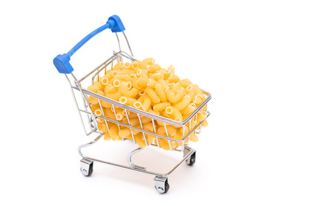 Uncooked Chifferi Rigati Pasta in Small Shopping Cart Isolated on White Background. A Crisis: Buying Cheap Food. Classic Dry Macaroni. Italian Culture and Cuisine. Raw Pasta - Isolationの写真素材