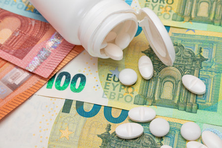 Expensive Medicine and Inflation Concept: Pills and Capsules on the Euro Banknotes. Global Pharmaceutical Industry and Big Pharma. Euro Money Billsの写真素材