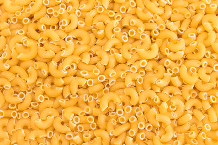 Uncooked Chifferi Rigati Pasta Background. Fat and Unhealthy Food. Classic Dry Macaroni Texture. Italian Culture and Cuisine. Raw Pastaの写真素材