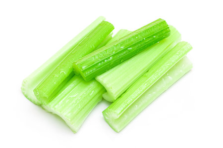 Fresh Chopped Celery Sticks with Water Drops Isolated on White Background. Vegan and Vegetarian Culture. Raw Food. Healthy Diet with Negative Calorie Contentの写真素材