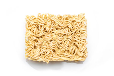 Uncooked Instant Noodles on White Plate. Raw Pasta. Dry Asian Fast Food. Quick Lunchの写真素材