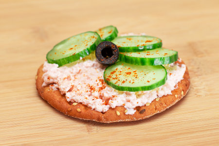 Crispy Cracker Sandwich with Fresh Cucumber, Fish Cream and Olives on Cutting Board. Easy Breakfast. Quick and Healthy Sandwiches. Crispbread with Tasty Filling. Healthy Dietary Snackの写真素材