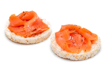Tasty Rice Cake Sandwiches with Fresh Salmon Slices Isolated on White. Easy Breakfast and Diet Food. Crispbread with Red Fish. Healthy Dietary Snacks - Isolationの写真素材