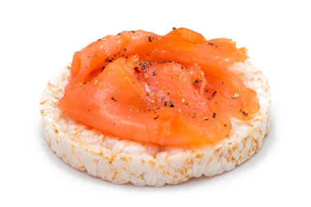 Tasty Rice Cake Sandwich with Fresh Salmon Slices Isolated on White. Easy Breakfast and Diet Food. Crispbread with Red Fish. Healthy Dietary Snack - Isolationの写真素材