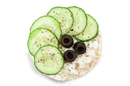 Rice Cake Sandwich with Fresh Cucumber, Cottage Cheese and Olives - Isolated on White. Easy Breakfast. Quick and Healthy Sandwiches. Crispbread with Tasty Filling. Healthy Dietary Snack - Isolationの写真素材