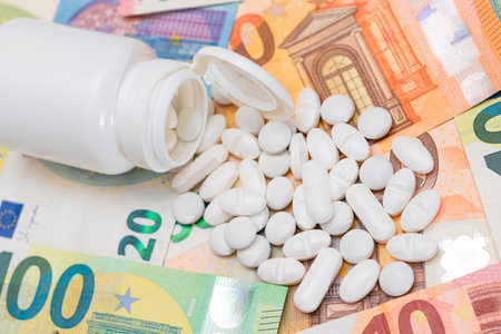 Expensive Medicine and Inflation Concept: Pills and Capsules on the Euro Banknotes. Global Pharmaceutical Industry and Big Pharma. Euro Money Billsの写真素材