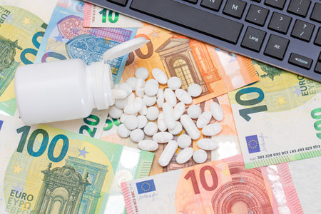 Expensive Medicine and Inflation Concept: Pills and Capsules on the Euro Banknotes. Global Pharmaceutical Industry and Big Pharma. Euro Money Billsの写真素材