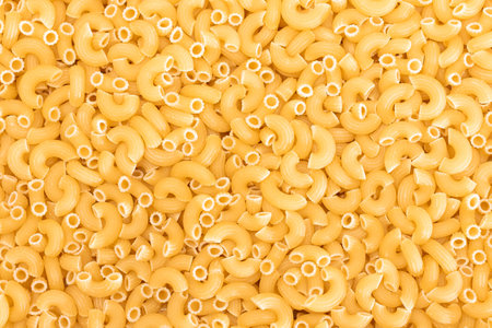 Uncooked Chifferi Rigati Pasta Background. Fat and Unhealthy Food. Classic Dry Macaroni Texture. Italian Culture and Cuisine. Raw Pastaの写真素材