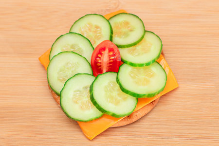 Crispy Cracker Sandwich with Fresh Cucumber, Tomato Cherry and Cheese on Cutting Board. Easy Breakfast. Diet Food. Quick and Healthy Sandwiches. Crispbread with Tasty Filling. Healthy Dietary Snackの写真素材
