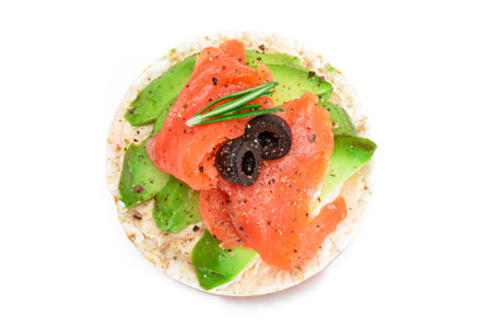 Rice Cake Sandwich with Fresh Salmon, Avocado and Olives - Isolated on White. Easy Breakfast. Diet Food. Quick and Healthy Sandwiches. Crispbread with Tasty Filling. Healthy Dietary Snack - Isolationの写真素材