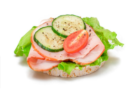 Light Breakfast. Quick and Healthy Sandwich. Rice Cake with Ham, Tomato, Fresh Cucumber and Green Salad - Isolated on Whiteの写真素材