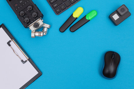 Top View of Photographers, Videographers or Video Bloggers Workplace. Digital Gadgets Lying on Blue Table - Flat Layの写真素材