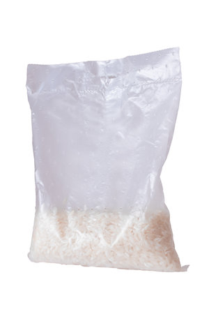 A Plastic Bag of White Long Grain Rice - Isolated on White Background. Small Transparent Package with Dry Rice - Isolationの写真素材