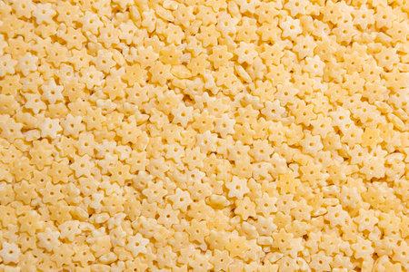 Uncooked Stelline Pasta: A Culinary Canvas of Stelline Macaroni, Creating a Lively and Textured Background for Gourmet Cooking. Dry Pasta. Raw Macaroni - Top View, Flat Layの写真素材