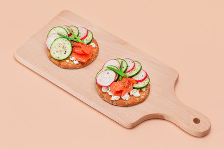 Crispy Cracker Sandwiches with Fresh Salmon, Cucumber, Radish, Cottage Cheese and Green Onions. Easy Breakfast. Quick and Healthy Sandwiches. Crispbread with Tasty Filling. Healthy Dietary Snackの写真素材