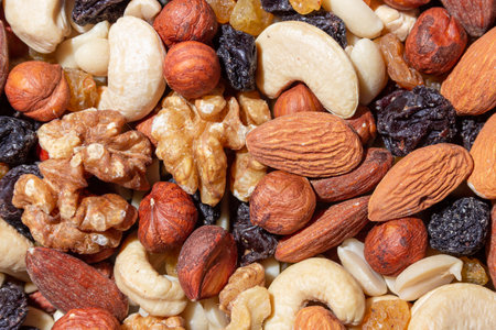 Mixed Nuts: Almonds, Walnuts, Cashews, Peanuts, Hazelnuts, Dried Prunes and Raisins. Different Nut Mix. Background from Various Nuts and Dried Fruitsの写真素材