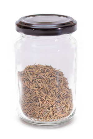 Rosemary Seasoning in a Small Glass Jar Isolated on White Backgroundの写真素材