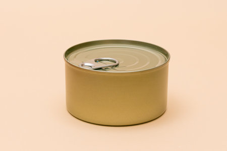 Unopened Tin Can with Blank Edge on Beige Background. Canned Food. Aluminum Can for Safe and Long...