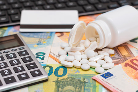 Ordering Medicines. Expensive Medicine and Inflation Concept: Pills and Capsules on the Euro Banknotes. Global Pharmaceutical Industry and Big Pharma. Trade in Medicinesの写真素材