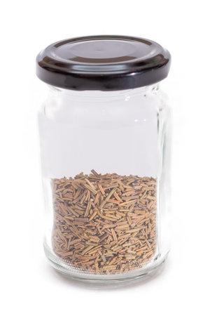 Rosemary Seasoning in a Small Glass Jar Isolated on White Backgroundの写真素材
